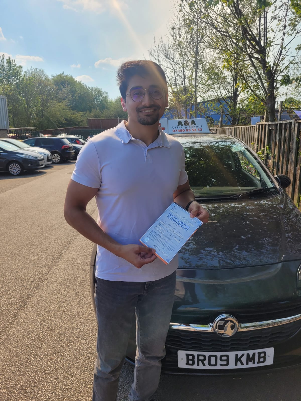 Man holding document beside car