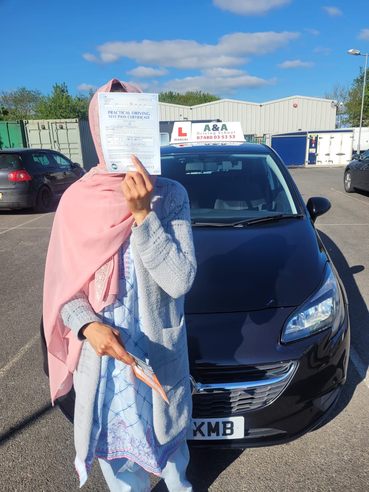 AnA Driving school - Person holding driving test certificate