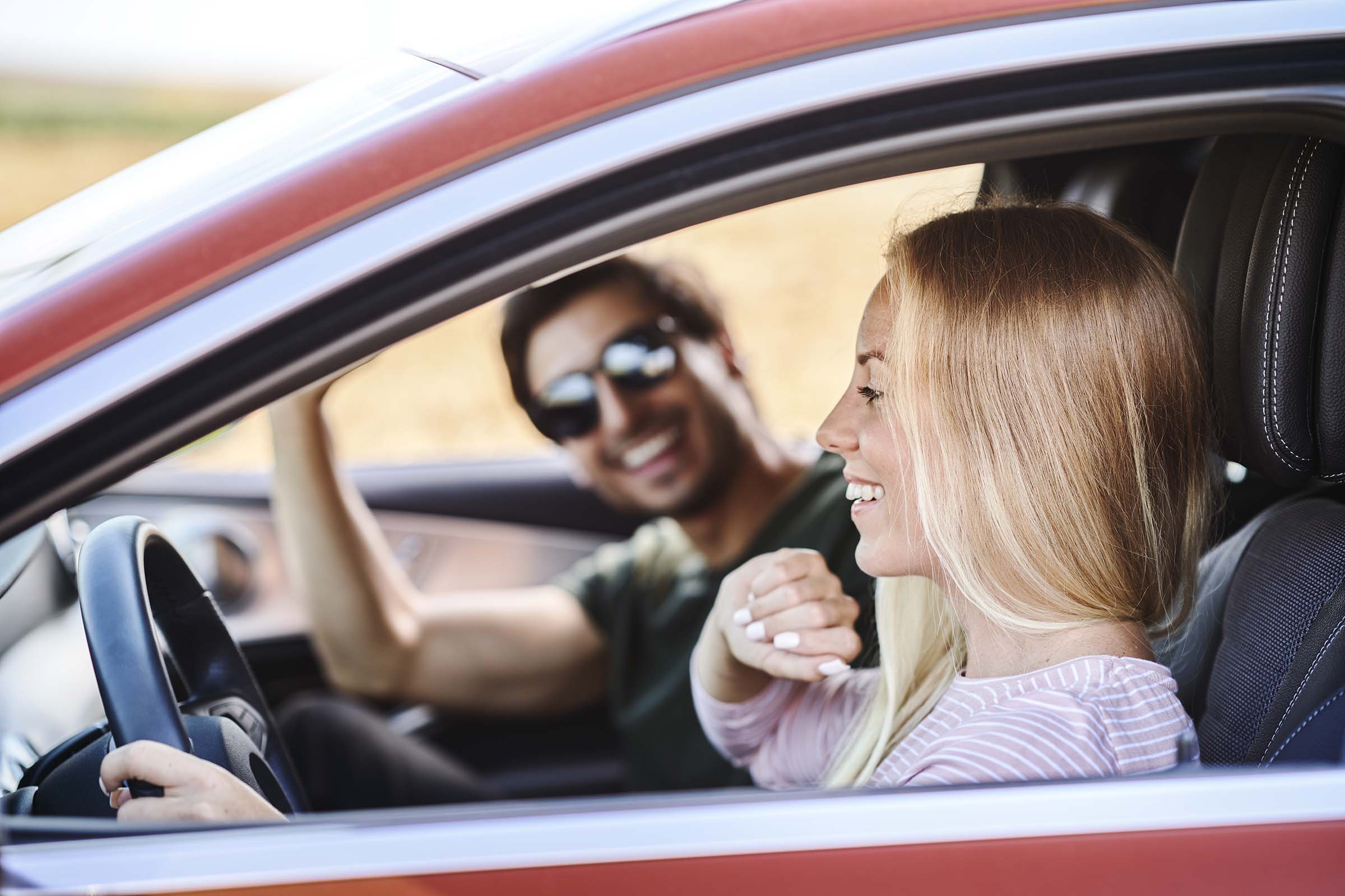 Happy couple enjoying a car ride