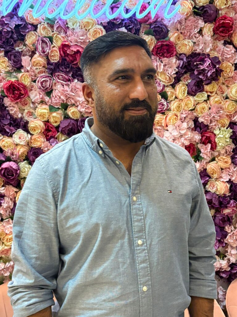 Man standing in front of flowers